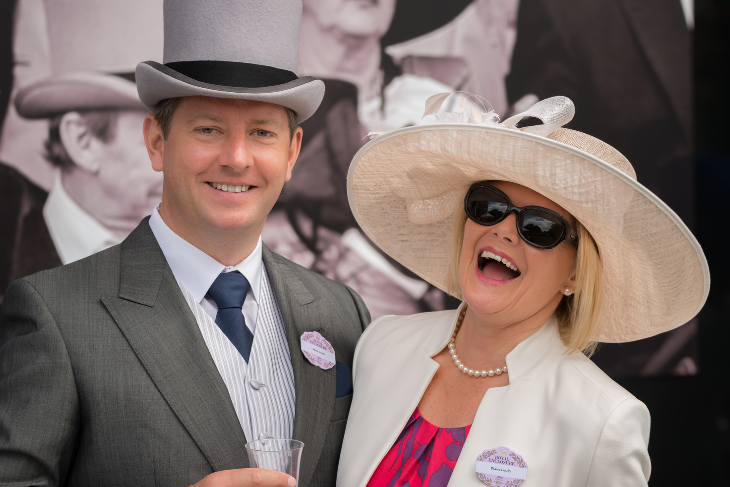 Couple at Royal Ascot laughing at camera